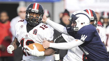 Aliquippa running back Terry Swanson, left, out runs Wyomissing defender Joseph Cacchione, right, for a 50-yard gain during the third quarter of today's PIAA Class AA high school football championship game in Hershey, Pa.