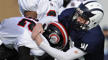 Aliquippa's Terry Swanson is taken down by Wyomissing's Joseph Cacchione in the PIAA class AA championship at Hersheypark Stadium today.
