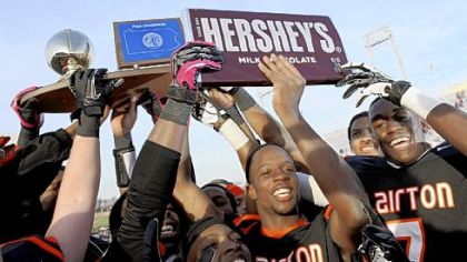 The Clairton Bears hoist the title trophy as they celebrate their fourth consecutive PIAA championship and extend Pennsylvania record to 63 wins in a row Friday at HersheyPark Stadium.