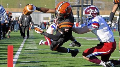 Clairton's Terrish Webb dives into the end zone for a touchdown against Dunmore's John Rinaldi in the PIAA Class A championship Friday at Hersheypark Stadium in Hershey, Pa.
