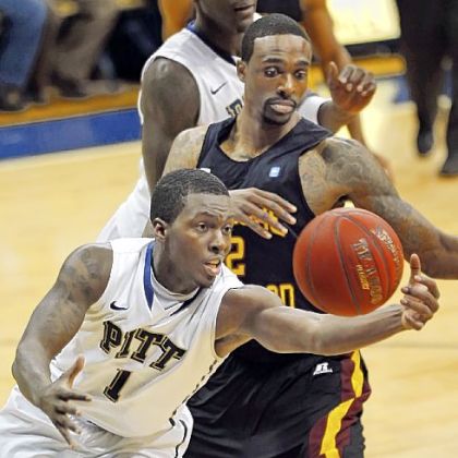 Tray Woodall beats Bethune-Cookman's Alex Smith to a loose ball in the second half Saturday night at Petersen Events Center. Pitt rolled to an 89-40 victory.