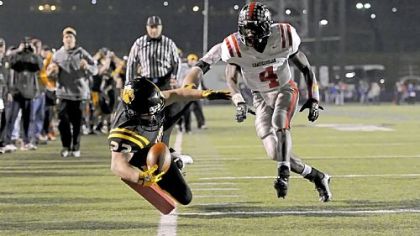 North Allegheny's Alex DeCiantis dives for the pylon to score a touchdown in the first half Saturday night in the PIAA Class AAAA final in Hershey, Pa.