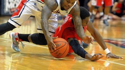 Velton Jones of Robert Morris runs down a loose ball ahead of Duquesne's Jerry Jones in the first half Saturday night at Sewall Center in Moon Township. Robert Morris defeated the Dukes, 91-69.