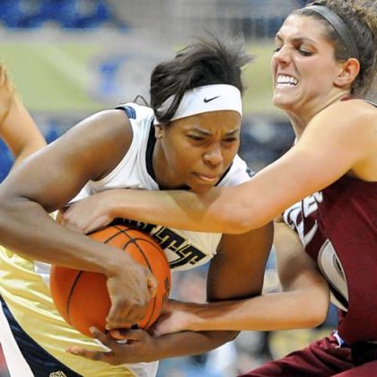 Pitt's Ashlee Anderson (left) battles Rider's Emily Fazzini for a loose ball in the first half of women's basketball game Sunday at the Peterson Events Center. Rider won, 65-48.