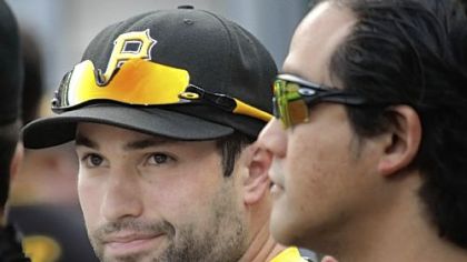 Neil Walker gets a pat on the back from physical therapist Erwin Valencia at an Aug. 16 game against the Dodgers.