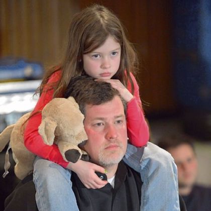 A man and his daughter arrive at Sunday evening's memorial service in Newtown, Conn.