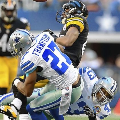 The Cowboys' (43) Gerald Sensabaugh separates the ball from Steelers receiver Emmanuel Sanders Sunday at Cowboys Stadium in Arlington, Texas.