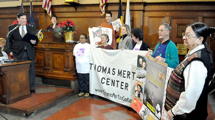 Pittsburgh city Councilman Bill Peduto reads a proclamation recognizing today as "Thomas Merton Center Day" on the center's 40th anniversary. The center is an advocate for economic, social and environmental justice.