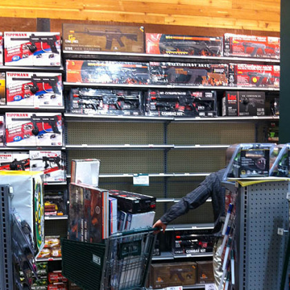 An employee at Dick's Sporting Goods in South Hills Village clears shelves Tuesday of Airsoft guns that resemble the AR-15.