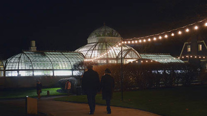 The festively lit conservatory and grounds of the Frick Art & Historical Center.