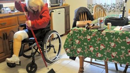 Catherine Fielding, a double amputee, sweeps the floors  in her Richland home. "I do my own cooking, my own laundry, my own dishes," she says.