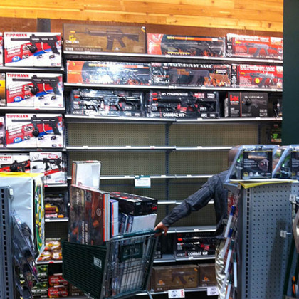 An employee at Dick's Sporting Goods in South Hills Village clears shelves Tuesday of Airsoft guns that resemble the AR-15.