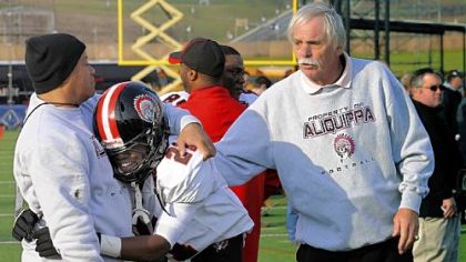Assistant coach Sherman McBride, left, and head coach Mike Zmijanac comfort Shaquere McBride, Sherman's son, after the Quips lost state title game.