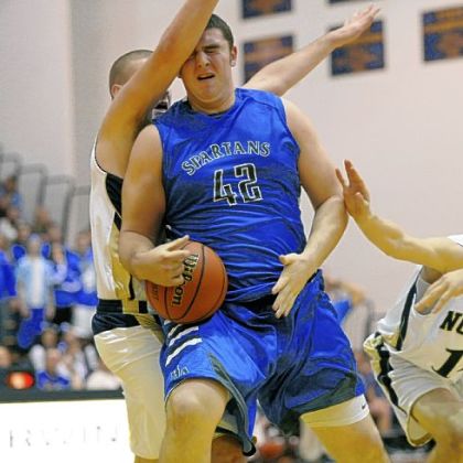 Hempfield's Tony Pilato is fouled by Norwin's Nick Idele in a Section 1-AAAA game last Friday at Norwin.