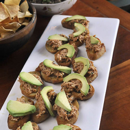 Crab salad topped with avocado slices. The base is a fried crouton made from a French baugette.