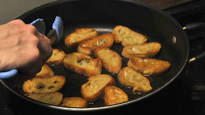 Prepping large croutons which will be fried and topped with crab and avocado.