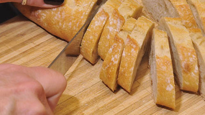 Prepping large croutons which will be fried and topped with crab and avocado.
