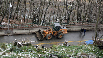 A Pittsburgh Public Works Department crew cleans debris on McArdle Roadway today after a minor landslide.