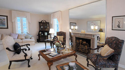 In the living room, the first thing that grabs your attention is the ornate Italian marble gas fireplace.