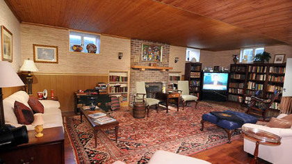 The basement game room has everything needed for family entertainment plus a wood-burning fireplace.