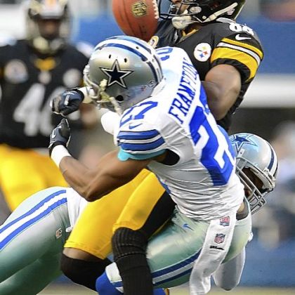 The Cowboys' Gerald Sensabaugh seperates the ball from Steelers receiver Emmanuel Sanders.
