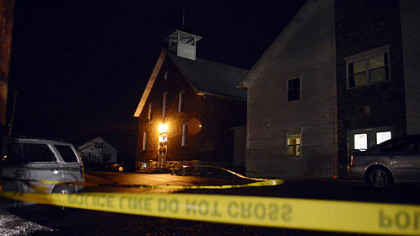 Officials investigate the scene at Juniata Valley Gospel Church Friday where one woman was shot and killed.