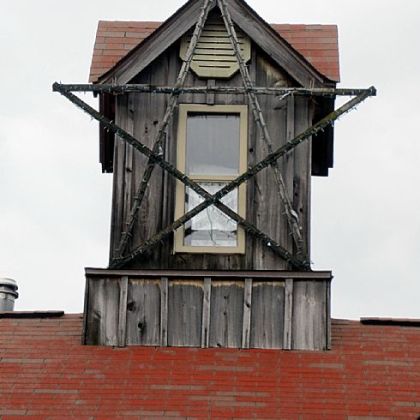 A cupola, topped by a copper rooster weather vane, is opened during the summer to let in cool night air. "Raising that cupola was quite a job," Mrs. Songer said, adding that she helped pull it through a hole in the roof.