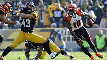 Bengals' A.J. Green carries around Steelers' Troy Polamalu in the first quarter at Heinz Field Sunday.