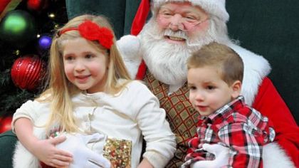 Sharlie Mecham, 4, of Munhall and her brother Cole, 2 enjoy their visit with Santa Ron.