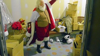 "Santa Ron"  gets dressed at the North Pole before going to work at Ross Park Mall.
