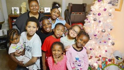 Toni Jones with her grandchildren, from left, Antionette, 2, Judah, 11, Makenzie, 8, Justice, 12, (back), Manuel, 7, Unique, 5, Treyhauna, 8, and Makeeda, 8, inside her Brighton Heights home.