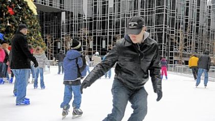 Eric Swanson, a University of Pittsburgh physics professor as well as an amateur hockey player, comes to a stop Saturday while demonstrating the science behind ice skating at the rink in PPG Place, Downtown.