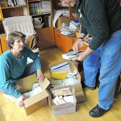 Former McMurray residents Amy and Jay Thomas, now of Newtown, Conn., sort prayer shawls and look through sympathy cards that people throughout the country have sent to Newtown United Methodist Church in the wake of the shooting at nearby Sandy Hook Elementary School.