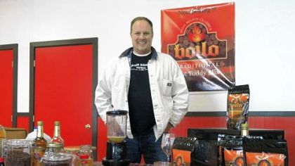 Chris Brokenshire poses in Ringtown, Schuylkill County, with his creation, a drink mix based on a traditional Pennsylvania coal-region winter cocktail called boilo.