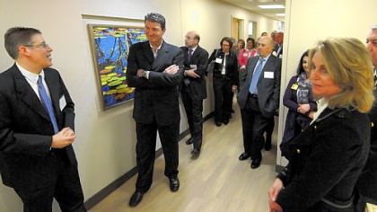 Mario Lemieux listens to tour guide David Wells at the opening of the new Mario Lemieux Center for Blood Cancers at the Hillman Cancer Center. Natalie Lemieux is at right.