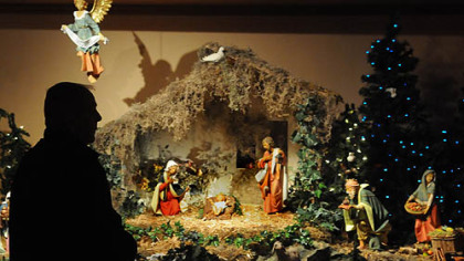 A visitor stops by the Chapel to view the creche in the chapel at UPMC Mercy.
