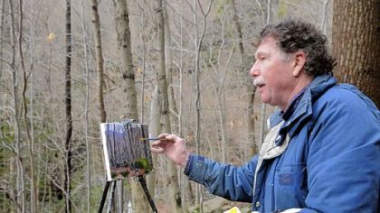 Charles "Bud" Gibbons paints in the Roaring Run Watershed near New Kensington, one of his favorite locations. He drew elements of his painting, "Winter," from this site and another in Forbes State Forest.