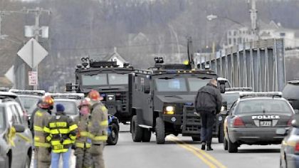 SWAT teams appear at the scene of a fire Monday in Webster, N.Y. Police say a man who killed two firefighters in a Christmas Eve ambush had served 17 years for manslaughter in the death of his grandmother.