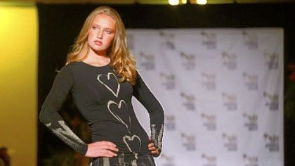 A model walks down the runway during the kickoff event of Pittsburgh Fashion Week in an eco-chic fashion show called "Green is the new black" at Soldiers & Sailors Memorial Hall in Oakland. Fashion Week expanded its reach in 2012, its third year.