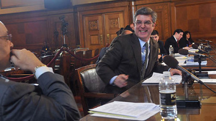 Pittsburgh City Council member Patrick Dowd, right, talks with council member Rev. Ricky Burgess before a vote was taken about  postponing parking meter enforcement  at night until summer 2013.  The measure passed with only Dowd abstaining.