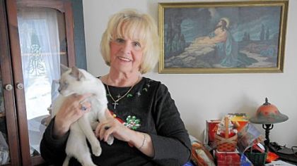 Susan Roberti holds her cat Lad in her Bethel Park home. Ms. Roberti recently was commended by the Bethel Park School District for rescuing a little girl who was lost.