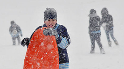 Samuel Silla, 11, of Houston, Texas, hauls his sled up the hill at the Schenley Oval, today. For Samuel, who was at the park with his father John and assorted siblings, it was his first time experiencing snow. The Sillas are visiting family in Pittsburgh.