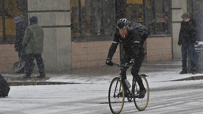 A bicyclist rolls down Liberty Avenue in Downtown Pittsburgh this morning.