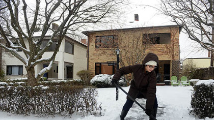 Zaynab Siddiqui of Squirrel Hill shovels off her walkway along Darlington Avenue in Squirrel Hill.