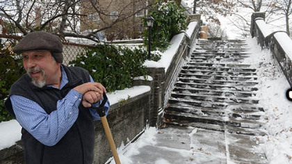 Don Martello of Squirrel Hill works to clear a staircase leading to his housing complex on the heels of a heavy snowstorm on Wednesday.