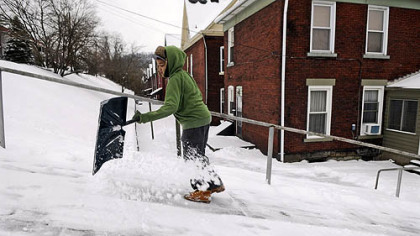 Dreshawn Craighead, 13, shovels while going up First Street in Wilmerding on Wednesday. He was looking for snow shoveling jobs in his neighborhood after yesterday's storm.