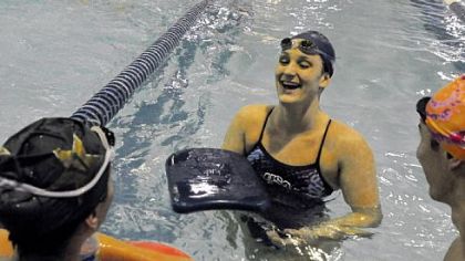Oakland Catholic's Leah Smith jokes with fellow Jewish Community Center Sailfish swim club members during a recent practice session.