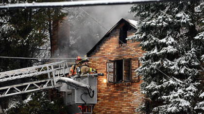 Firefighters battle a fire that killed two people Thursday at 916 McNeilly Road in Mt. Lebanon.