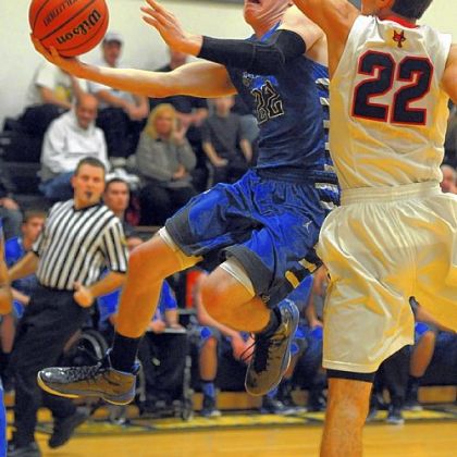 Tyler Handlan of Hempfield dips under Fox Chapel's Matthew D'Amico for a shot Thursday at Montour.