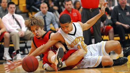 Peters Township's Rylen Faloni, left, and North Allegheny's Elijah Zeise battle for possession of a loose ball in the first half Friday at North Allegheny. North Allegheny won, 71-35.